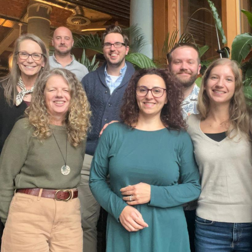 a group photo of the atlas translations team where all team members are smiling and in relaxed poses.